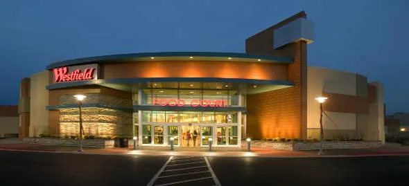 Retail storefront with facade and canopy lighting at dusk