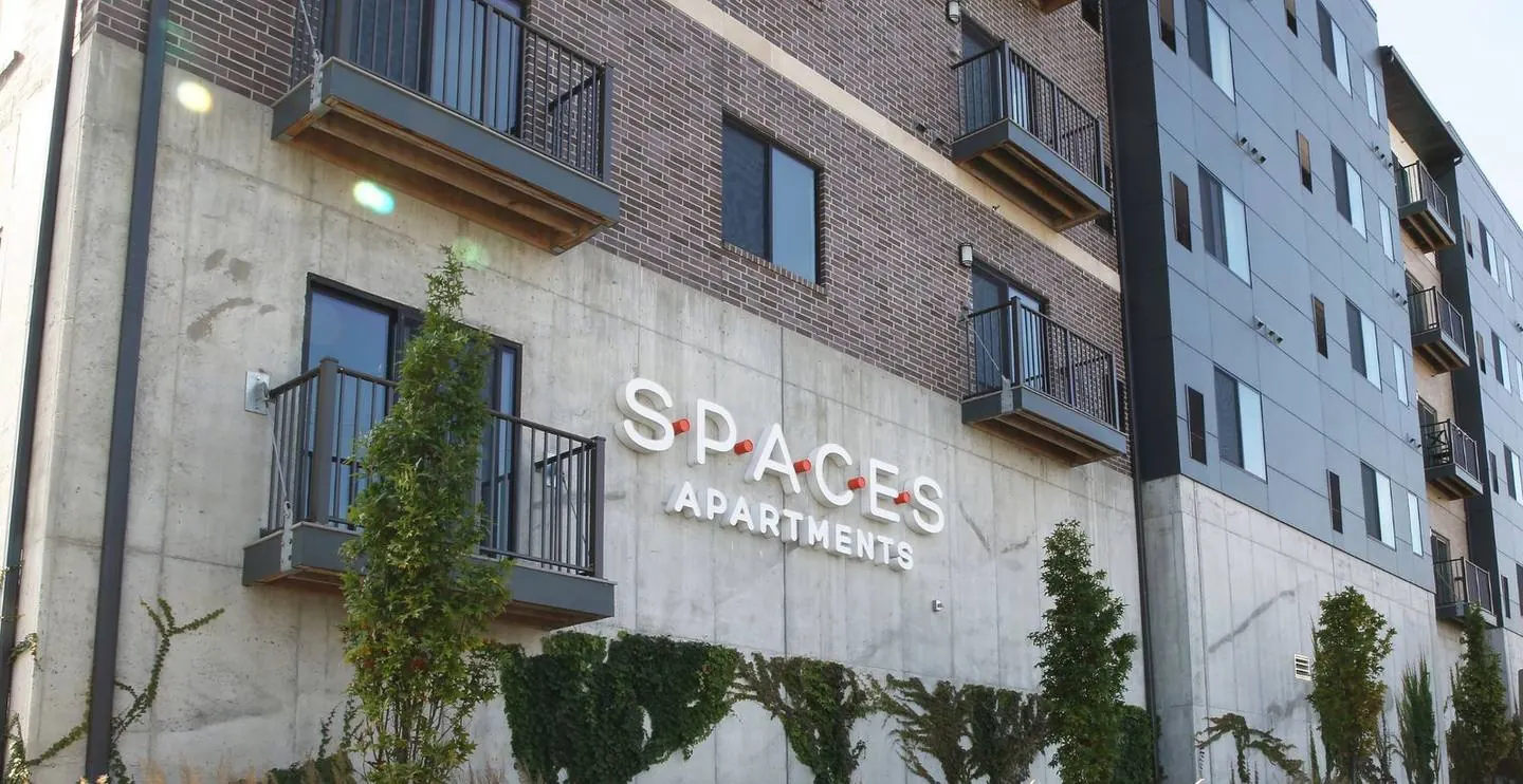 Spaces Apartments building in Omaha with brick, concrete and metal panel facade and balconies